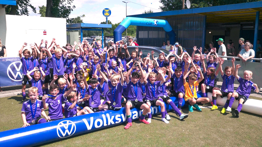 Kids celebrating next to an inflatable AirPitch football pitch during 3v3 Deutschland Tour 2025