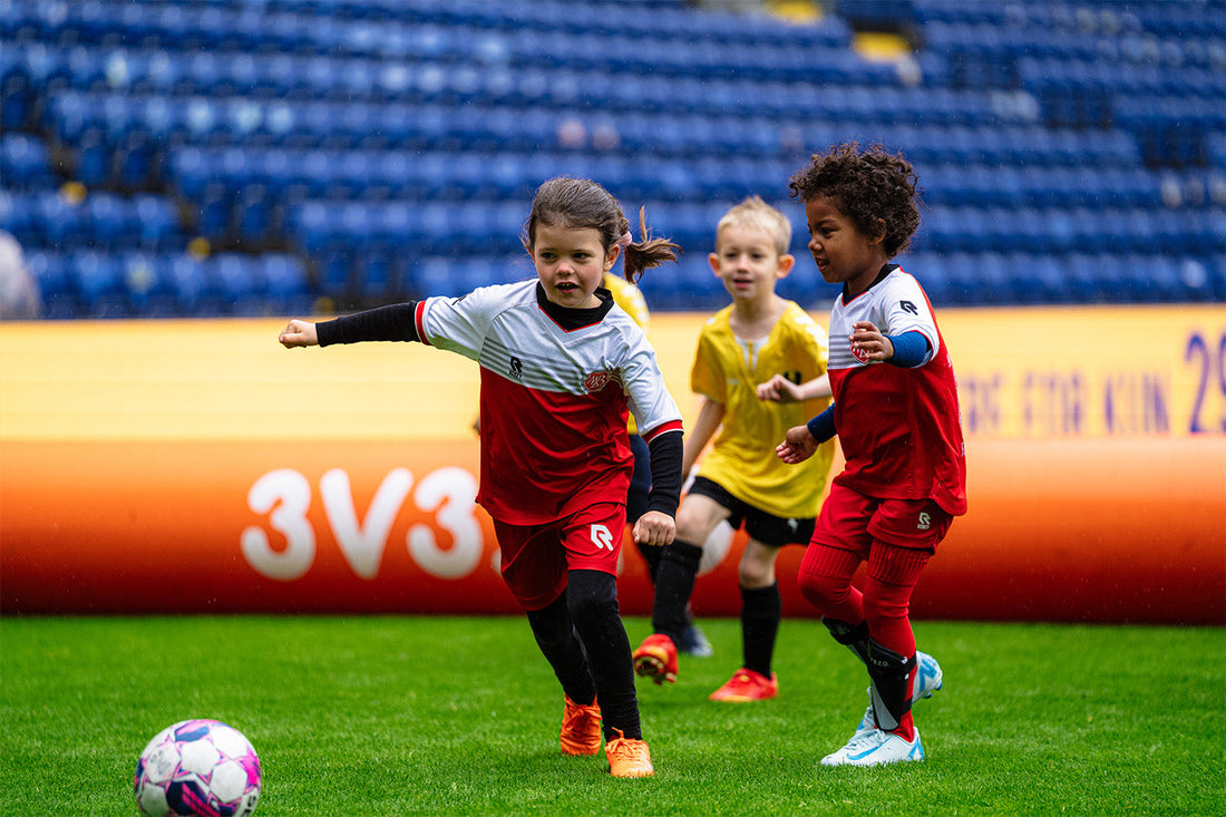 kids playing football inside an airpitch inflatable football pitch in a 3v3 tournament in denmark