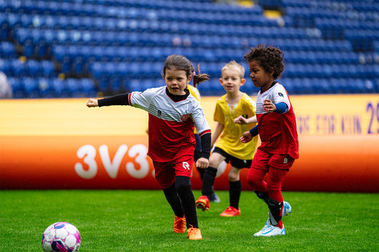 kids playing football inside an airpitch inflatable football pitch in a 3v3 tournament in denmark