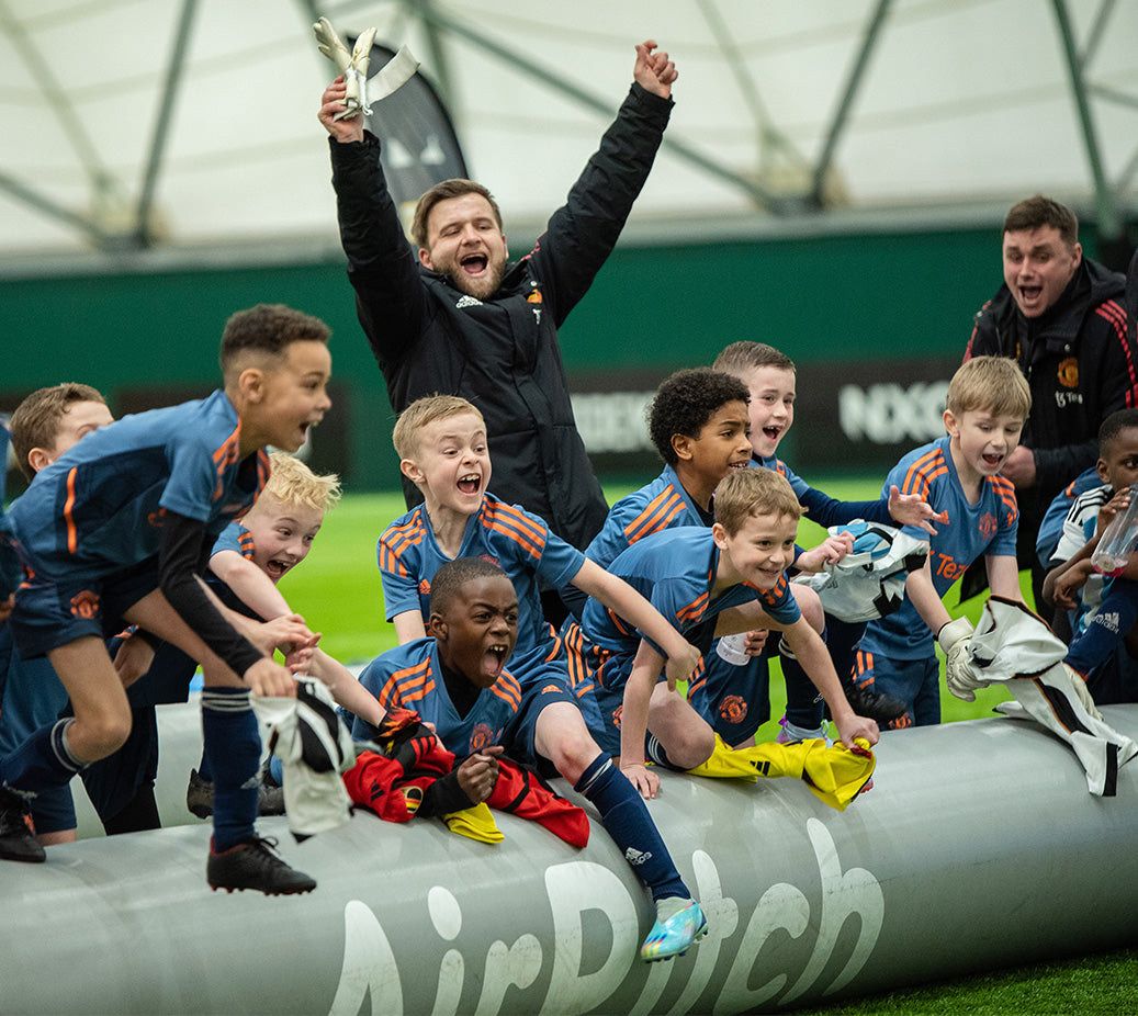 manchester united academy coach and players celebrating 3v3 airpitch inflatable football pitch tournament win